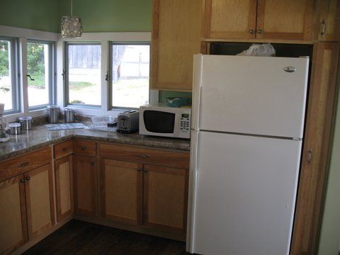 Kitchen with microwave, refrigerator, facing east